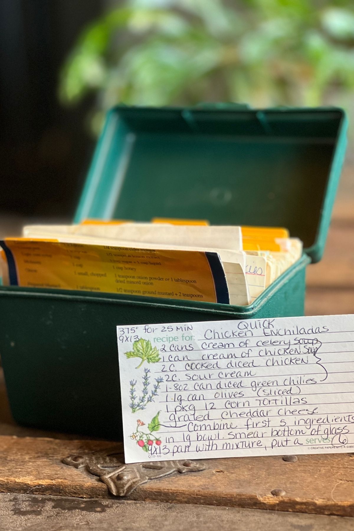 A green recipe box with handwritten recipes.